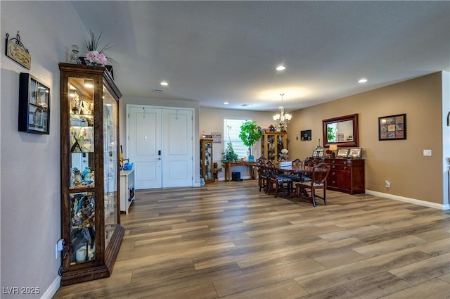9511 Star Vista Ct, Las Vegas, NV 89149 - dining room with a chandelier, light wood-style flooring, recessed lighting, and baseboards