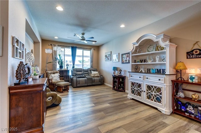 9511 Star Vista Ct, Las Vegas, NV 89149 - living room featuring a ceiling fan, wood finished floors, recessed lighting, and baseboards