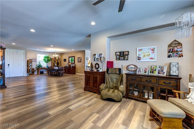 9511 Star Vista Ct, Las Vegas, NV 89149 - living room featuring a chandelier, recessed lighting, wood finished floors, a ceiling fan, and baseboards