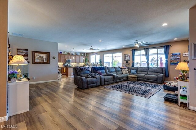 9511 Star Vista Ct, Las Vegas, NV 89149 - living area featuring a ceiling fan, wood finished floors, recessed lighting, and baseboards