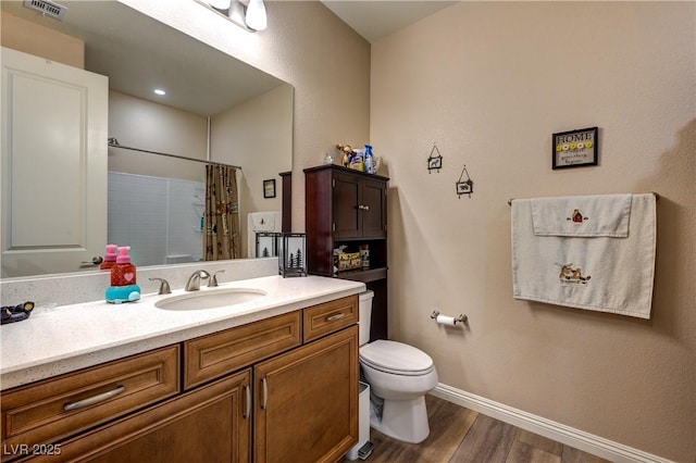9511 Star Vista Ct, Las Vegas, NV 89149 - full bathroom featuring wood finished floors, toilet, baseboards, vanity, and a shower with shower curtain