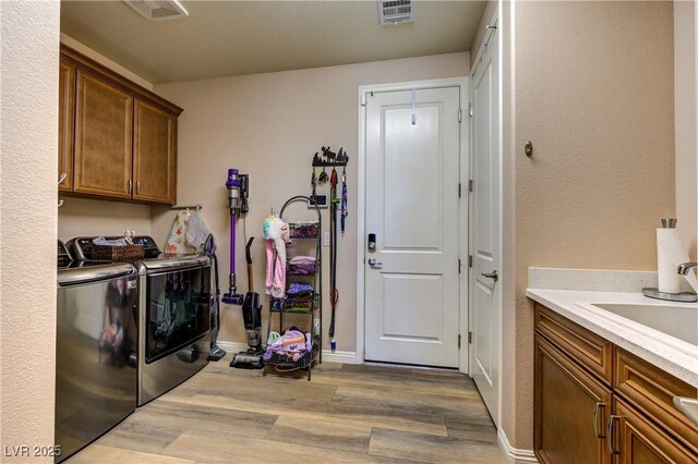 9511 Star Vista Ct, Las Vegas, NV 89149 - washroom with cabinet space, washing machine and clothes dryer, wood finished floors, and baseboards