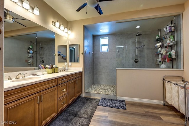 9511 Star Vista Ct, Las Vegas, NV 89149 - full bath featuring ceiling fan, wood finished floors, a walk in shower, double vanity, and baseboards