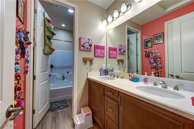 9511 Star Vista Ct, Las Vegas, NV 89149 - bathroom with wood finished floors, double vanity, and shower / tub combination