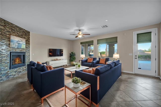 12283 Lost Treasure Ave, Las Vegas, NV 89138 - tiled living room featuring visible vents, ceiling fan, and a stone fireplace
