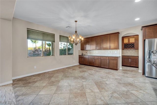 12283 Lost Treasure Ave, Las Vegas, NV 89138 - kitchen featuring a notable chandelier, stainless steel fridge with ice dispenser, recessed lighting, tasteful backsplash, and visible vents
