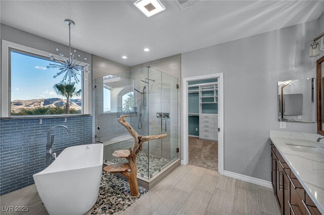 12283 Lost Treasure Ave, Las Vegas, NV 89138 - full bathroom with double vanity, a sink, a soaking tub, and a stall shower