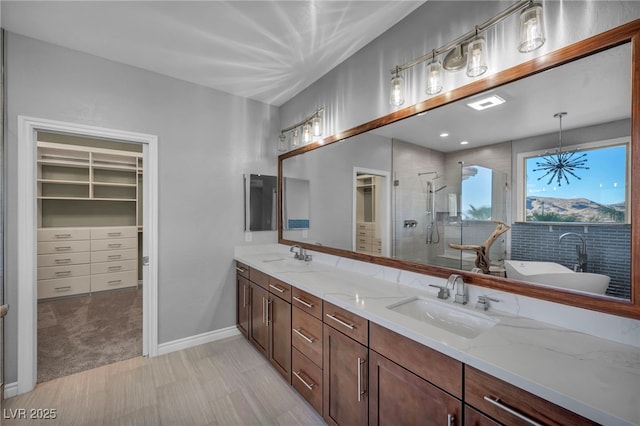 12283 Lost Treasure Ave, Las Vegas, NV 89138 - full bathroom featuring double vanity, a sink, a walk in closet, and a shower stall