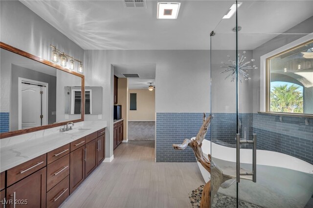 12283 Lost Treasure Ave, Las Vegas, NV 89138 - full bathroom featuring a freestanding tub, vanity, wood finished floors, and visible vents
