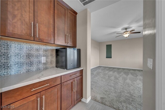 12283 Lost Treasure Ave, Las Vegas, NV 89138 - kitchen featuring visible vents, light carpet, baseboards, ceiling fan, and tasteful backsplash