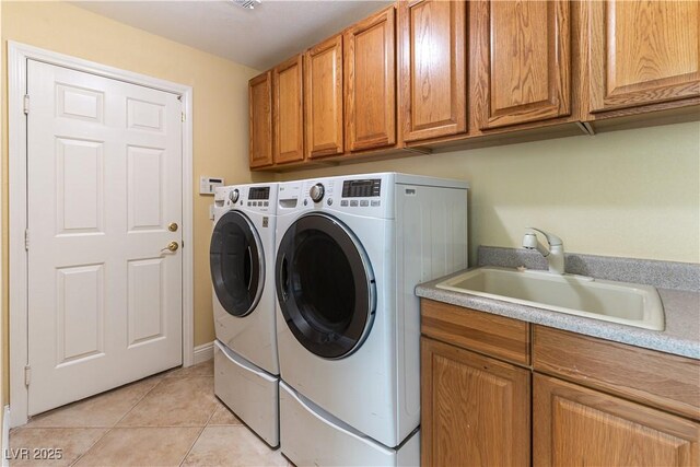 812 Eaglewood Dr, Las Vegas, NV 89144 - washroom with separate washer and dryer, cabinet space, and light tile patterned floors
