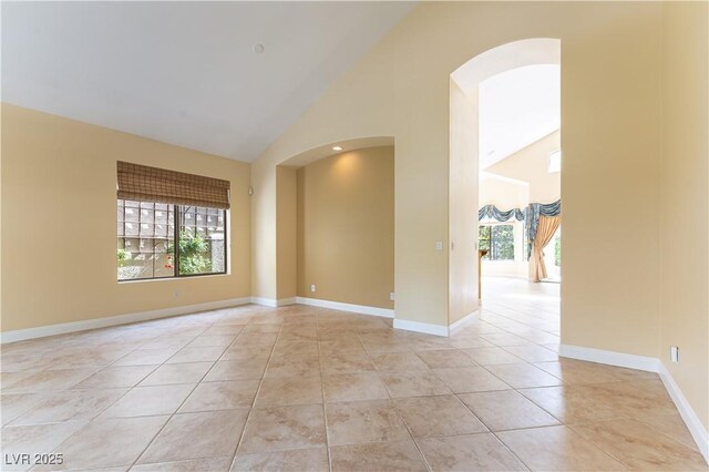 812 Eaglewood Dr, Las Vegas, NV 89144 - spare room featuring arched walkways, high vaulted ceiling, and light tile patterned floors