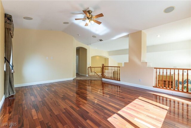 812 Eaglewood Dr, Las Vegas, NV 89144 - spare room featuring arched walkways, ceiling fan, wood finished floors, and lofted ceiling