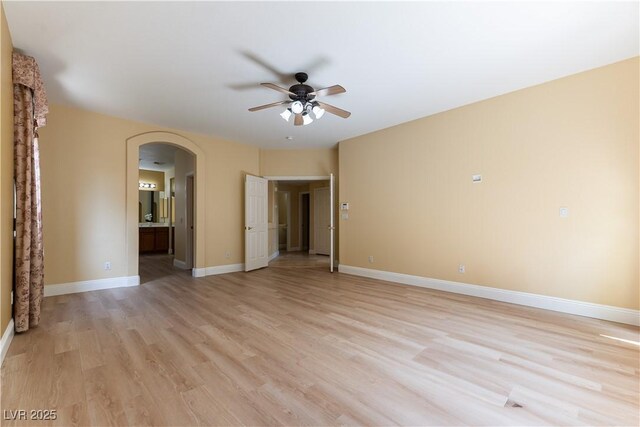 812 Eaglewood Dr, Las Vegas, NV 89144 - unfurnished room featuring arched walkways, ceiling fan, and light wood-style flooring