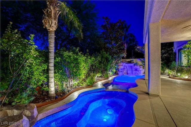 812 Eaglewood Dr, Las Vegas, NV 89144 - pool at twilight with a pool with connected hot tub and a patio