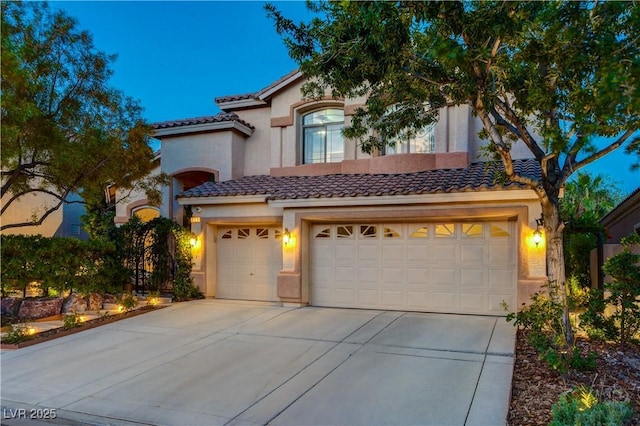 812 Eaglewood Dr, Las Vegas, NV 89144 - mediterranean / spanish home with concrete driveway, a tile roof, stucco siding, and an attached garage