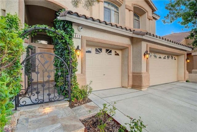 812 Eaglewood Dr, Las Vegas, NV 89144 - view of front of property featuring driveway, a garage, stucco siding, a tile roof, and a gate