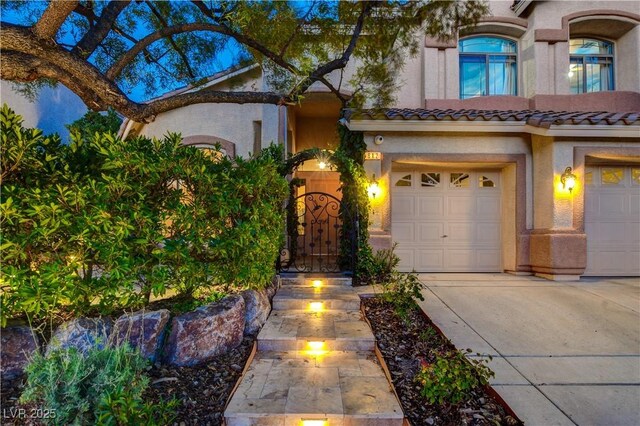 812 Eaglewood Dr, Las Vegas, NV 89144 - mediterranean / spanish house with concrete driveway, stucco siding, a garage, and a tile roof