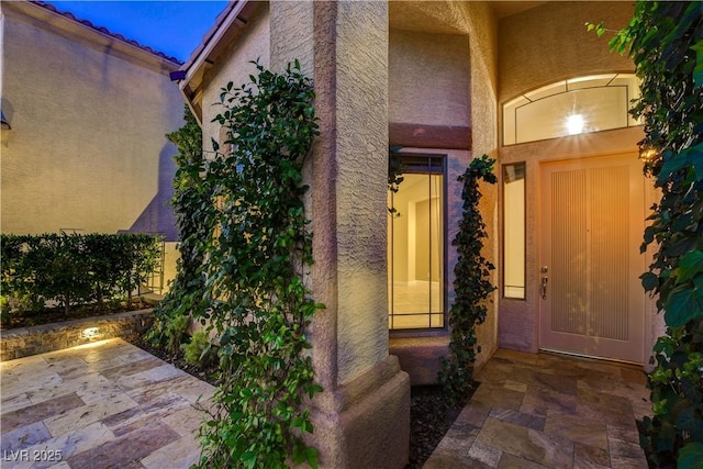 812 Eaglewood Dr, Las Vegas, NV 89144 - doorway to property featuring stucco siding and a patio area