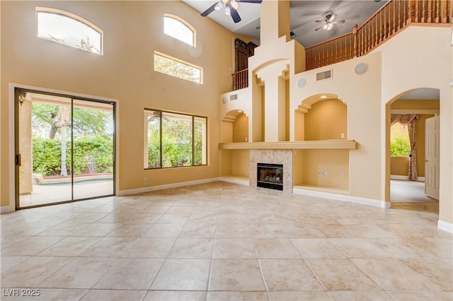 812 Eaglewood Dr, Las Vegas, NV 89144 - unfurnished living room featuring ceiling fan, a high ceiling, healthy amount of natural light, and tile patterned flooring