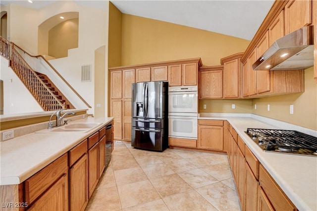 812 Eaglewood Dr, Las Vegas, NV 89144 - kitchen featuring stainless steel appliances, under cabinet range hood, high vaulted ceiling, light countertops, and light tile patterned floors