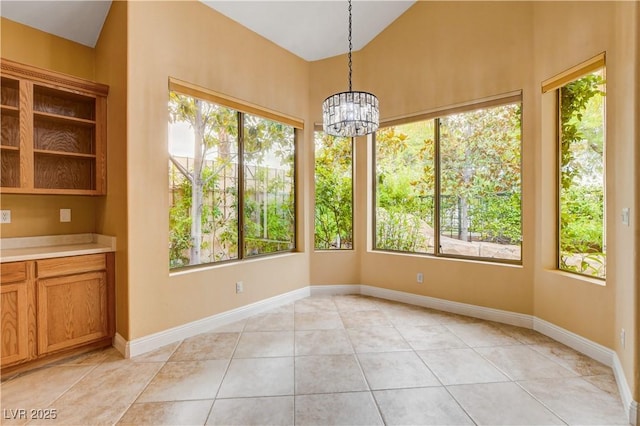 812 Eaglewood Dr, Las Vegas, NV 89144 - unfurnished dining area with healthy amount of natural light, light tile patterned flooring, a chandelier, and vaulted ceiling