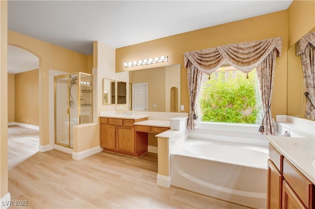 812 Eaglewood Dr, Las Vegas, NV 89144 - full bathroom featuring a stall shower, vanity, a garden tub, and wood finished floors