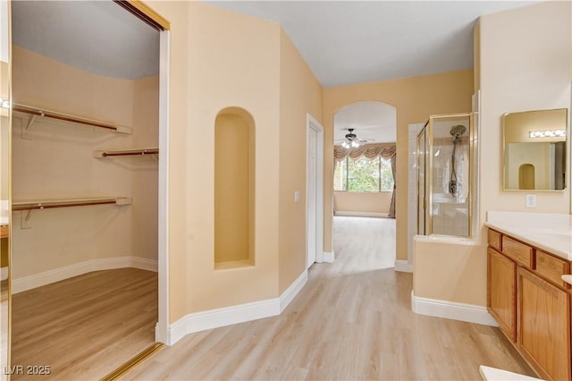 812 Eaglewood Dr, Las Vegas, NV 89144 - bathroom with wood finished floors, vanity, a shower stall, and a spacious closet
