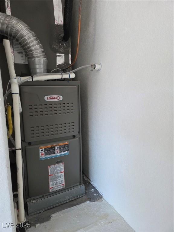 utility room featuring heating unit