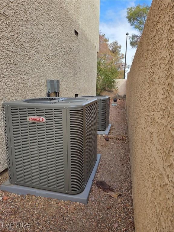 details with central air condition unit and stucco siding