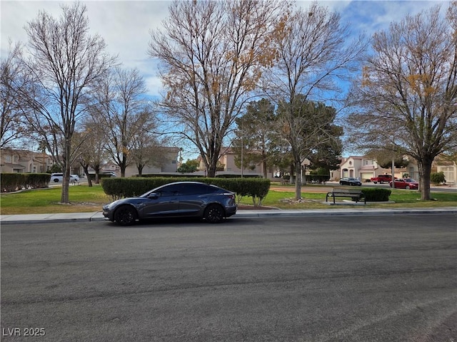 view of road featuring sidewalks, curbs, and a residential view