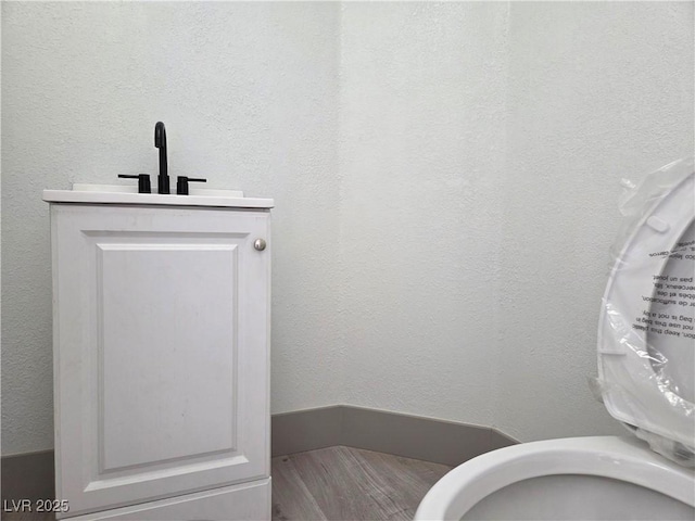 bathroom with vanity and wood finished floors