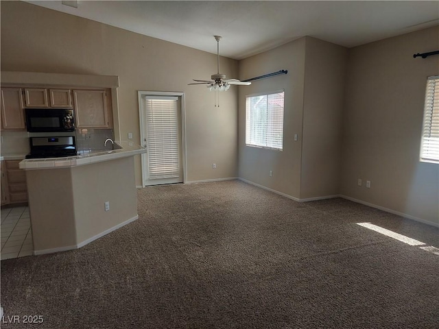 900 Heavenly Hills Ct Unit 219, Las Vegas, NV 89145 - kitchen featuring black microwave, tile countertops, electric stove, vaulted ceiling, and light colored carpet