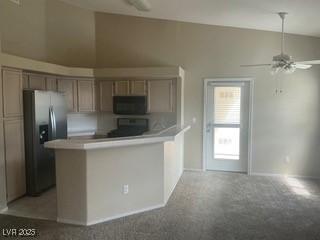 900 Heavenly Hills Ct Unit 219, Las Vegas, NV 89145 - kitchen featuring stainless steel fridge, a ceiling fan, vaulted ceiling, light carpet, and light countertops