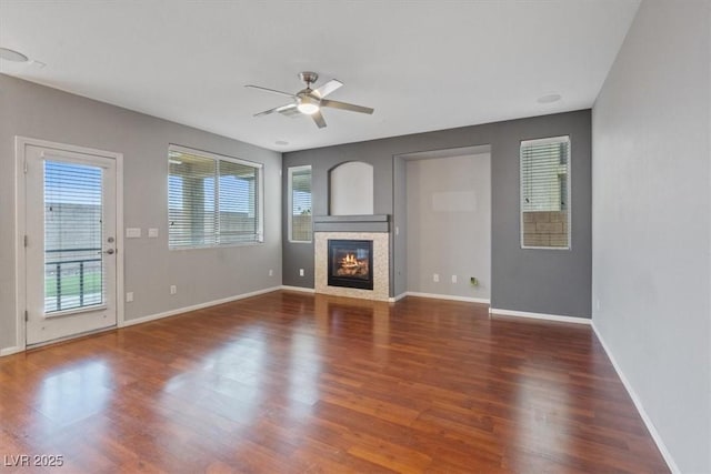 640 Finch Island Ave, Henderson, NV 89015 - unfurnished living room featuring baseboards, a fireplace, a ceiling fan, and wood finished floors