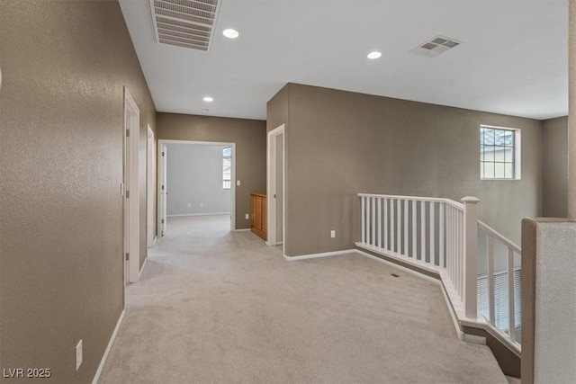 640 Finch Island Ave, Henderson, NV 89015 - corridor with baseboards, visible vents, light carpet, and an upstairs landing