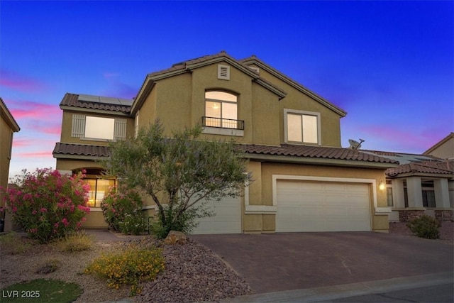 640 Finch Island Ave, Henderson, NV 89015 - mediterranean / spanish home featuring solar panels, a garage, a balcony, aphalt driveway, and stucco siding