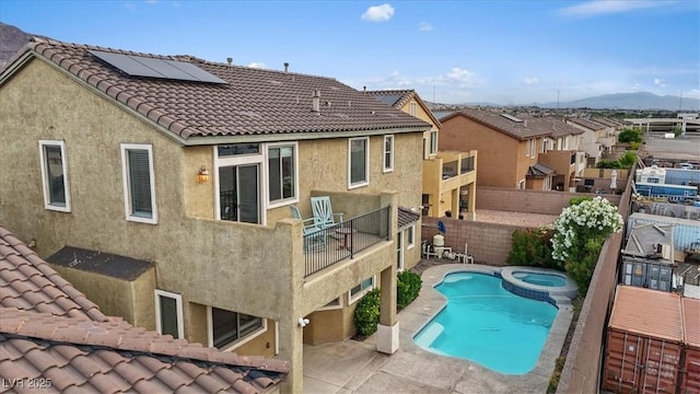 640 Finch Island Ave, Henderson, NV 89015 - view of swimming pool featuring a pool with connected hot tub, a residential view, a patio area, a mountain view, and a fenced backyard
