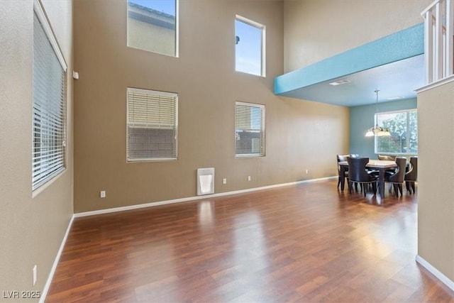 640 Finch Island Ave, Henderson, NV 89015 - dining area featuring baseboards, a towering ceiling, wood finished floors, and visible vents