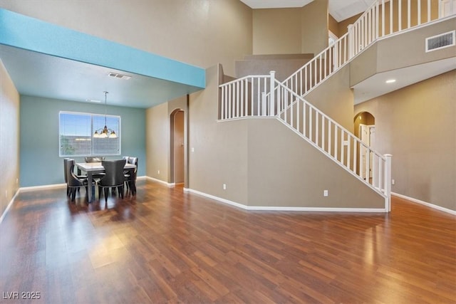 640 Finch Island Ave, Henderson, NV 89015 - dining area with arched walkways, visible vents, wood finished floors, and stairway