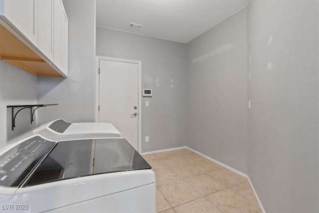 640 Finch Island Ave, Henderson, NV 89015 - laundry area with visible vents, light tile patterned flooring, baseboards, washing machine and clothes dryer, and cabinet space