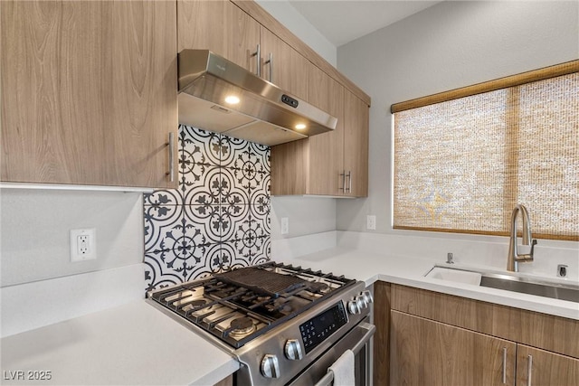 kitchen with gas stove, exhaust hood, a sink, and light countertops