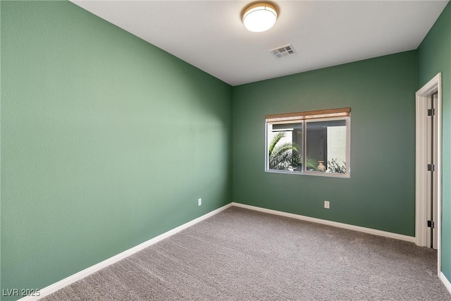 carpeted empty room featuring visible vents and baseboards