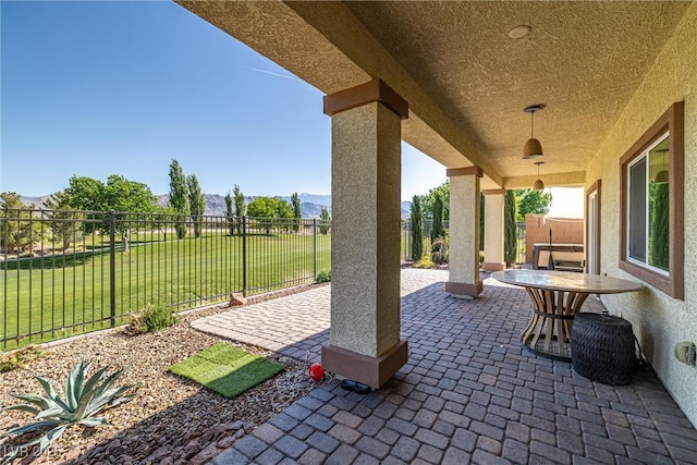 view of patio featuring a mountain view and a fenced backyard
