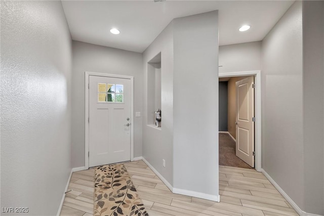 entrance foyer with light wood-style floors, recessed lighting, and baseboards