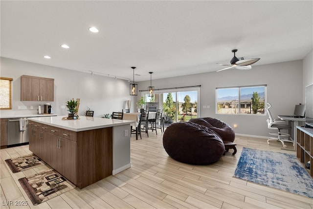 kitchen with recessed lighting, a center island, light countertops, dishwasher, and open floor plan