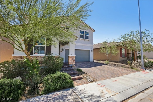 view of front of home with stone siding, decorative driveway, stucco siding, and a garage