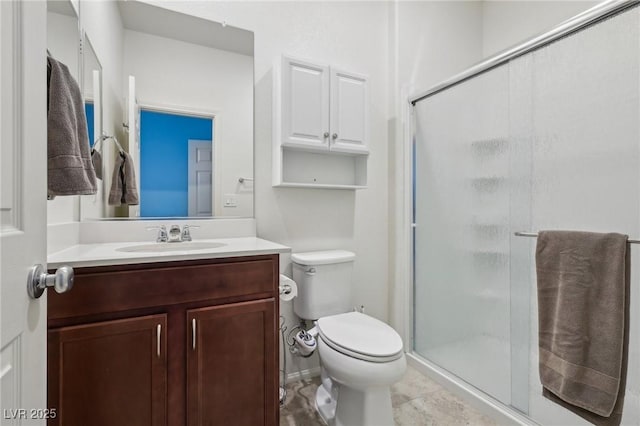 bathroom featuring toilet, vanity, and a shower stall