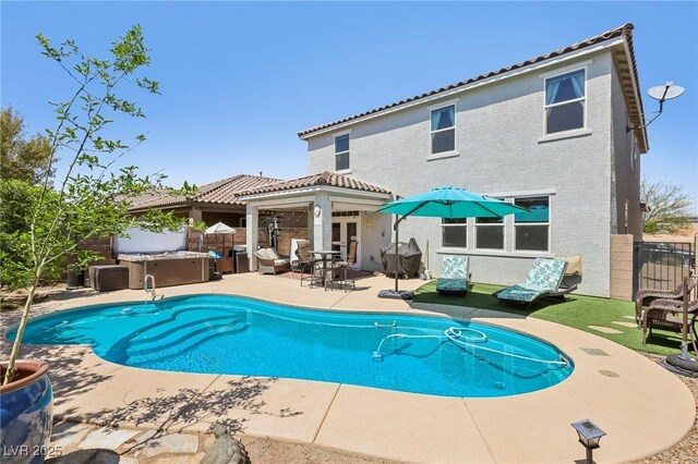 view of pool featuring a patio, a fenced in pool, a jacuzzi, and fence