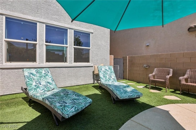 view of patio / terrace featuring fence